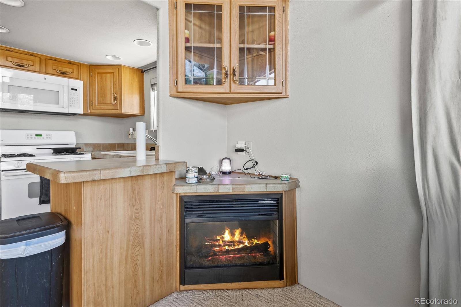 92 Sunshine Loop Fairplay, CO 80440 - Photo 17 of 30 a kitchen with stainless steel appliances granite countertop a stove a sink and a refrigerator with wooden cabinets