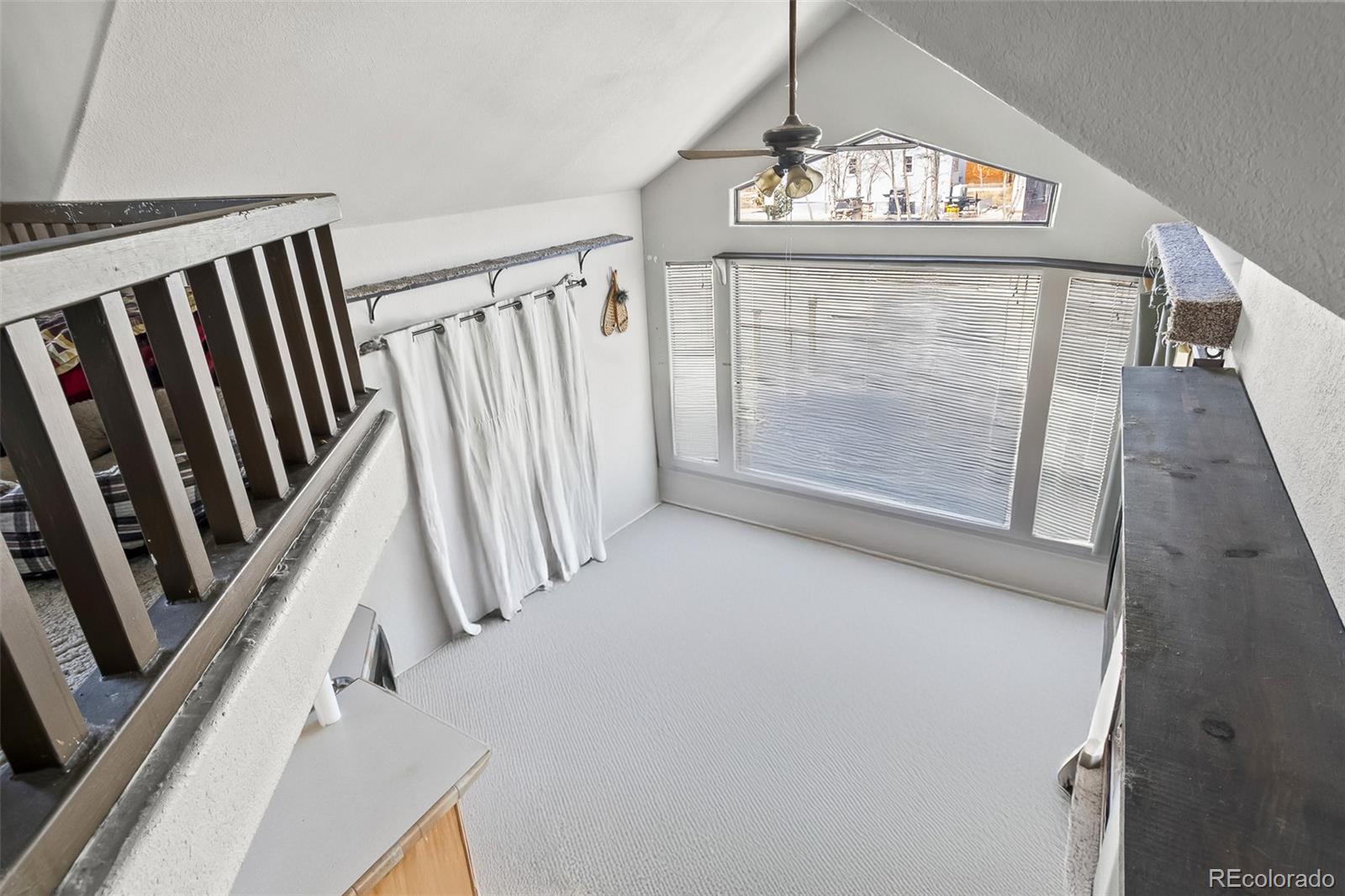92 Sunshine Loop Fairplay, CO 80440 - Photo 27 of 30 a view of a livingroom with wooden floor and stairs