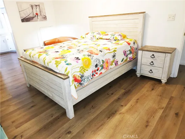 a bed sitting in a bedroom next to a window