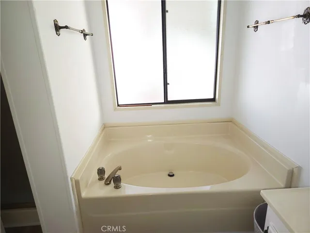 a white bath tub sitting next to a window