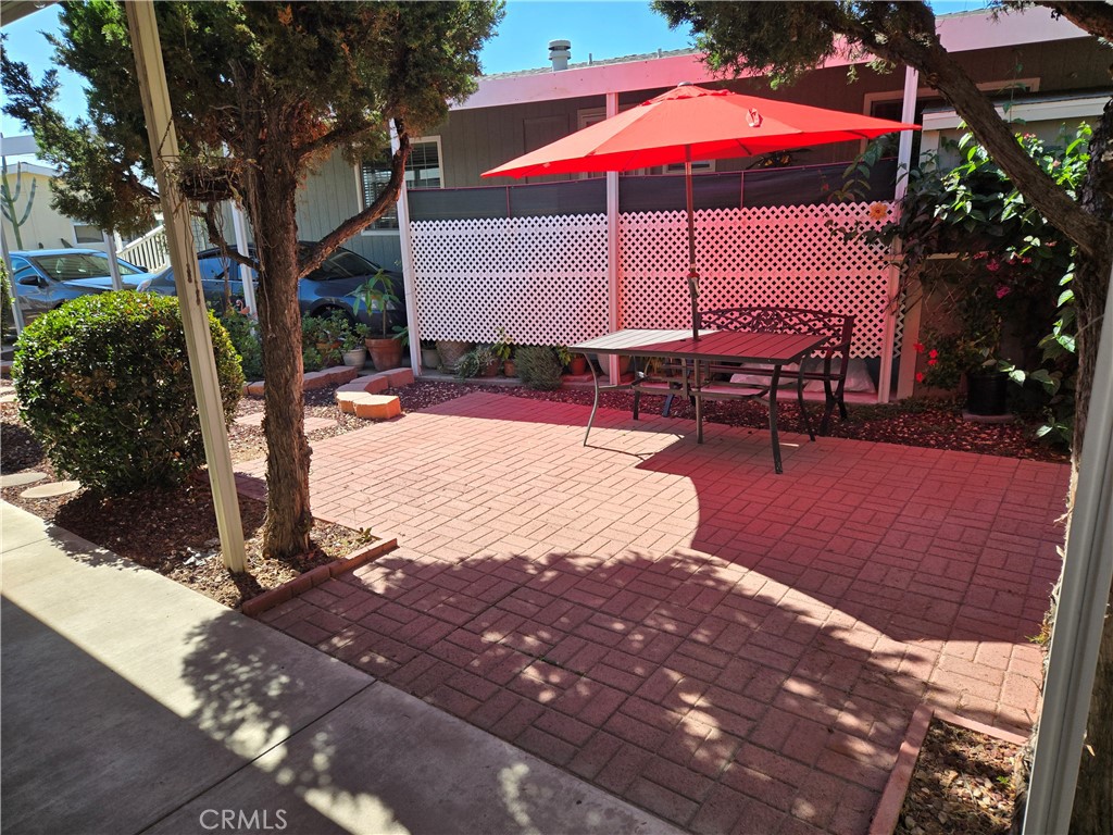 840 East Foothill Boulevard, Unit 203 Azusa, CA 91702 - Photo 3 of 21 a view of a patio with a table and chairs under an umbrella
