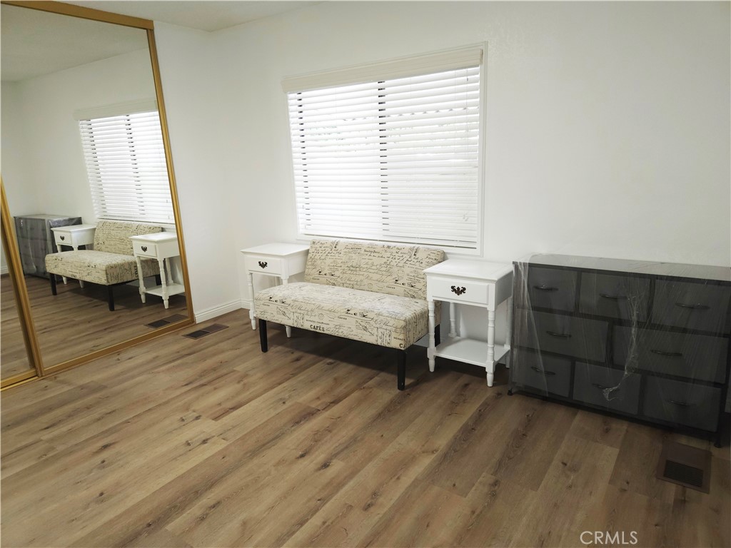 840 East Foothill Boulevard, Unit 203 Azusa, CA 91702 - Photo 10 of 21 a living room with furniture and a wooden floor