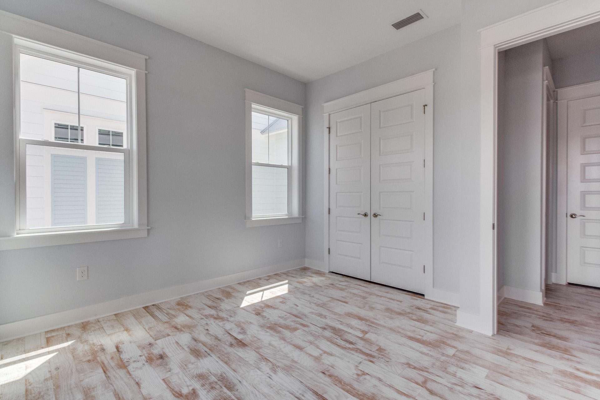 65 Pine Lands Loop Inlet Beach East, Unit C Inlet Beach, FL 32461 - Photo 31 of 47 a view of empty room with wooden floor and fan