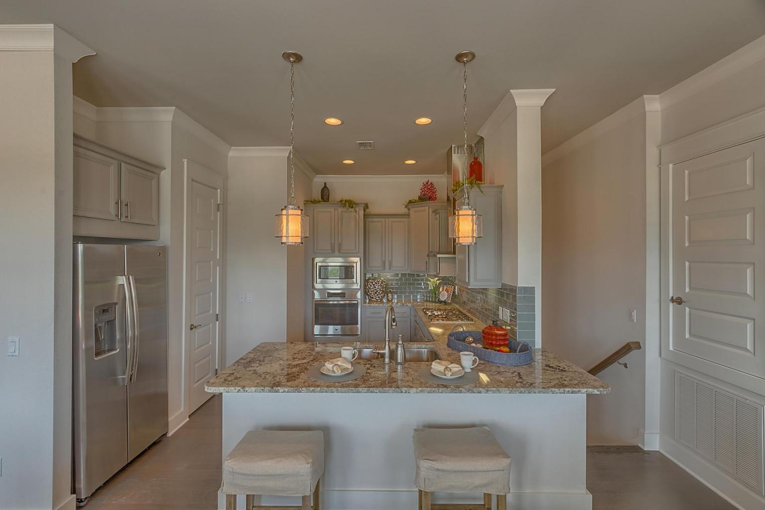 65 Pine Lands Loop Inlet Beach East, Unit C Inlet Beach, FL 32461 - Photo 5 of 47 a kitchen with kitchen island cabinets and refrigerator