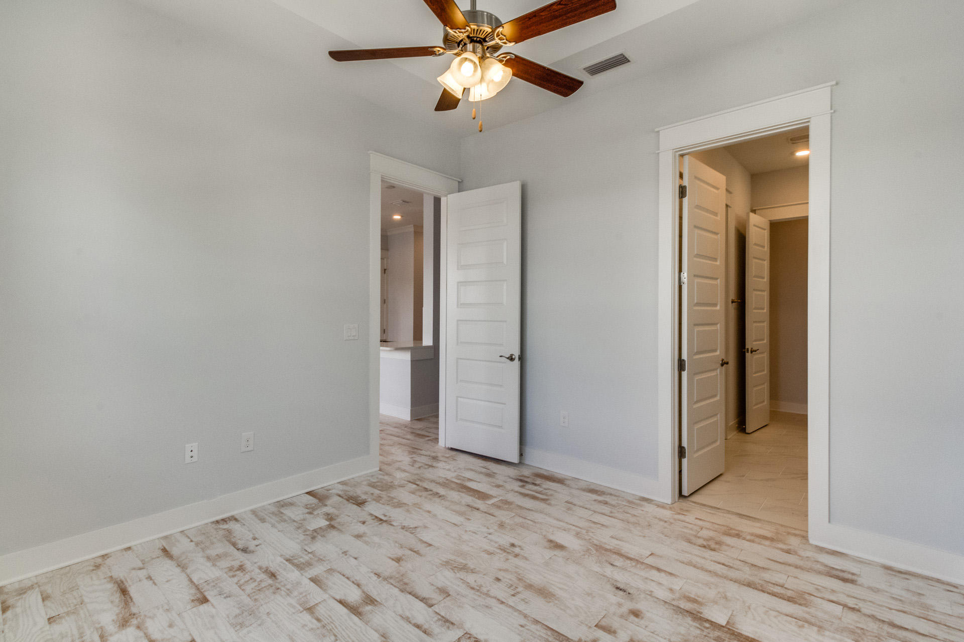 65 Pine Lands Loop Inlet Beach East, Unit C Inlet Beach, FL 32461 - Photo 43 of 47 a view of a livingroom with a ceiling fan and wooden floor