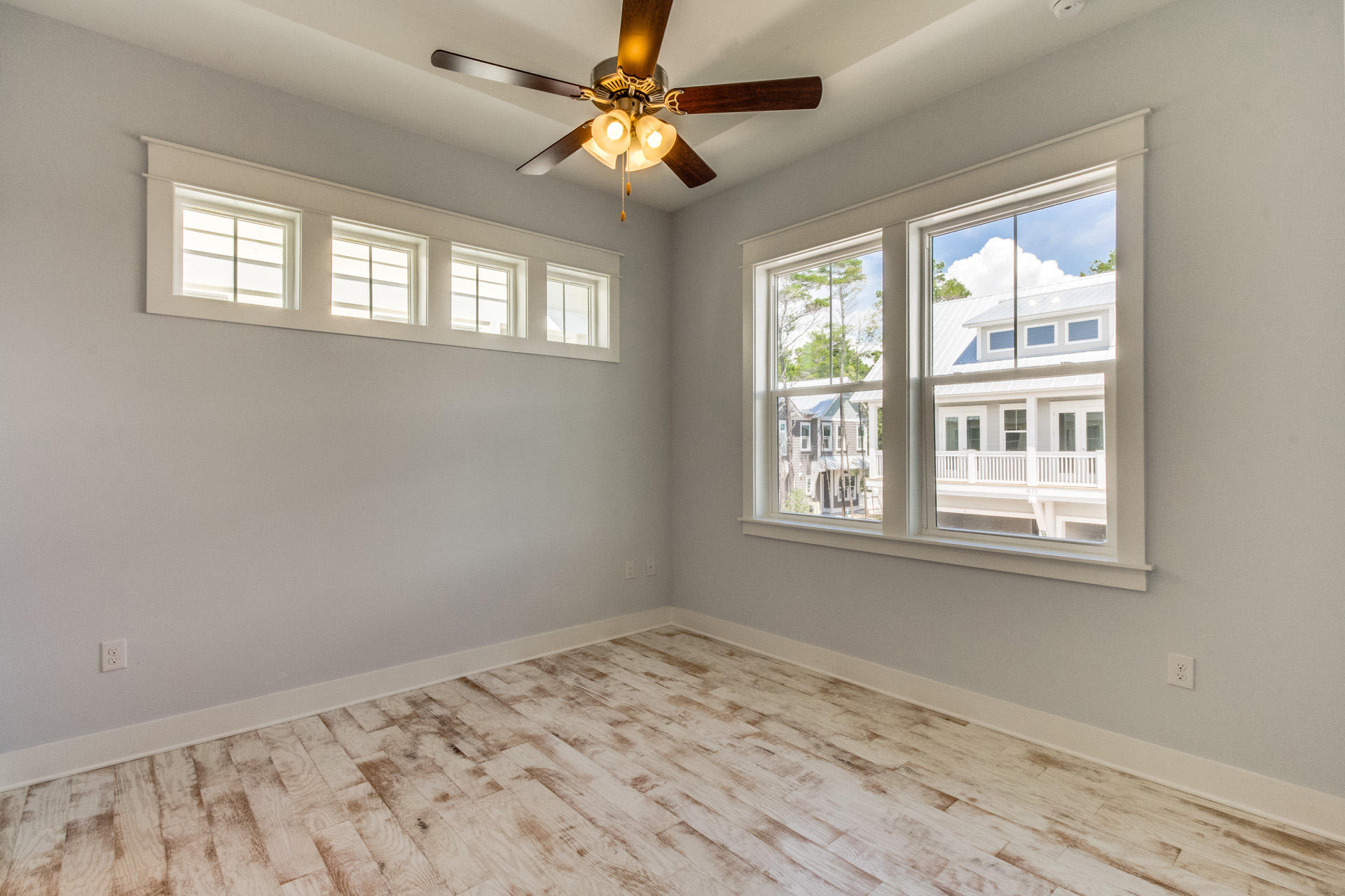 65 Pine Lands Loop Inlet Beach East, Unit C Inlet Beach, FL 32461 - Photo 44 of 47 a view of a bedroom with wooden floor and windows