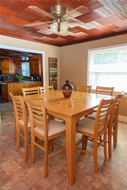 7014 Ridge Road Lexington, NC 27295 - Photo 17 of 21 Warm ceilings in dining room and kitchen area compliment the home.