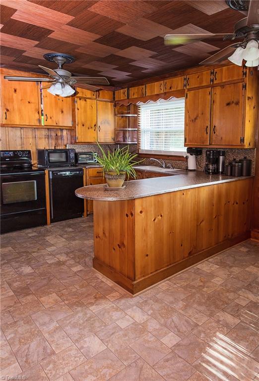 7014 Ridge Road Lexington, NC 27295 - Photo 18 of 21 Eat-in kitchen area to the right. Dishwasher, stove, refrigerator all remain. New flooring in kitchen and dining room.