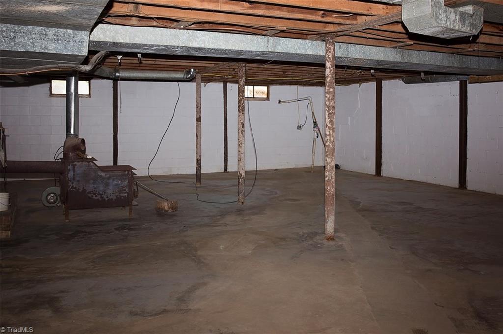 7014 Ridge Road Lexington, NC 27295 - Photo 19 of 21 Full unfinished basement with wood stove that remains.