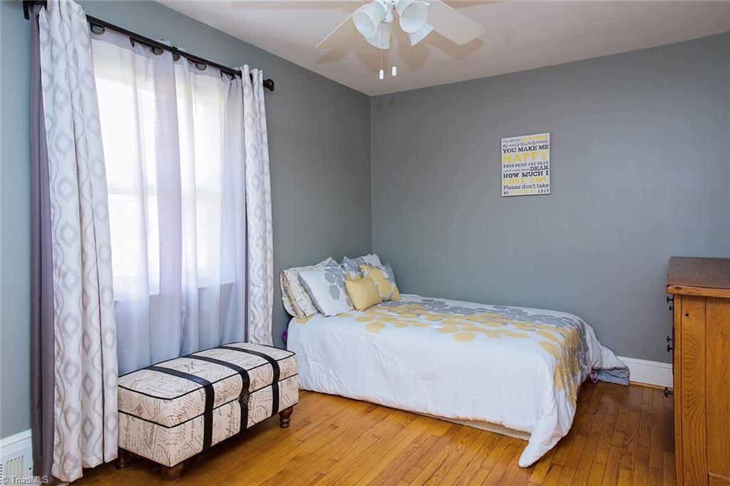 7014 Ridge Road Lexington, NC 27295 - Photo 6 of 21 Middle bedroom also has wood flooring and a double door closet.