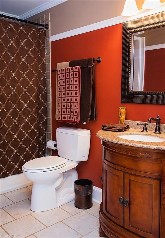 7014 Ridge Road Lexington, NC 27295 - Photo 8 of 21 Bathroom has been remodeled with tile flooring and tile surround. Decorative molding adds a warm touch.