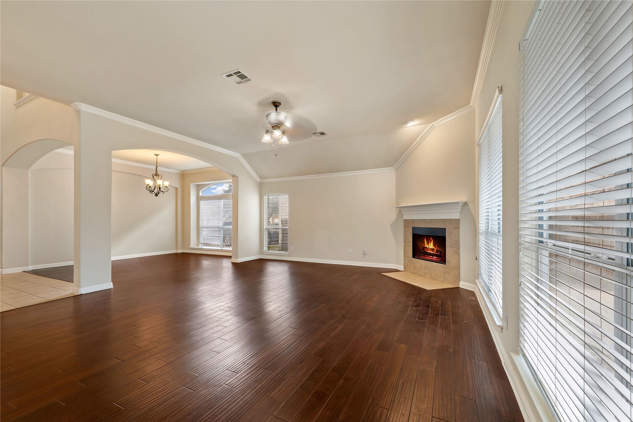 1102 Canyon Maple Road Pflugerville, TX 78660 - Photo 3 of 21 a view of an empty room with wooden floor and a fireplace