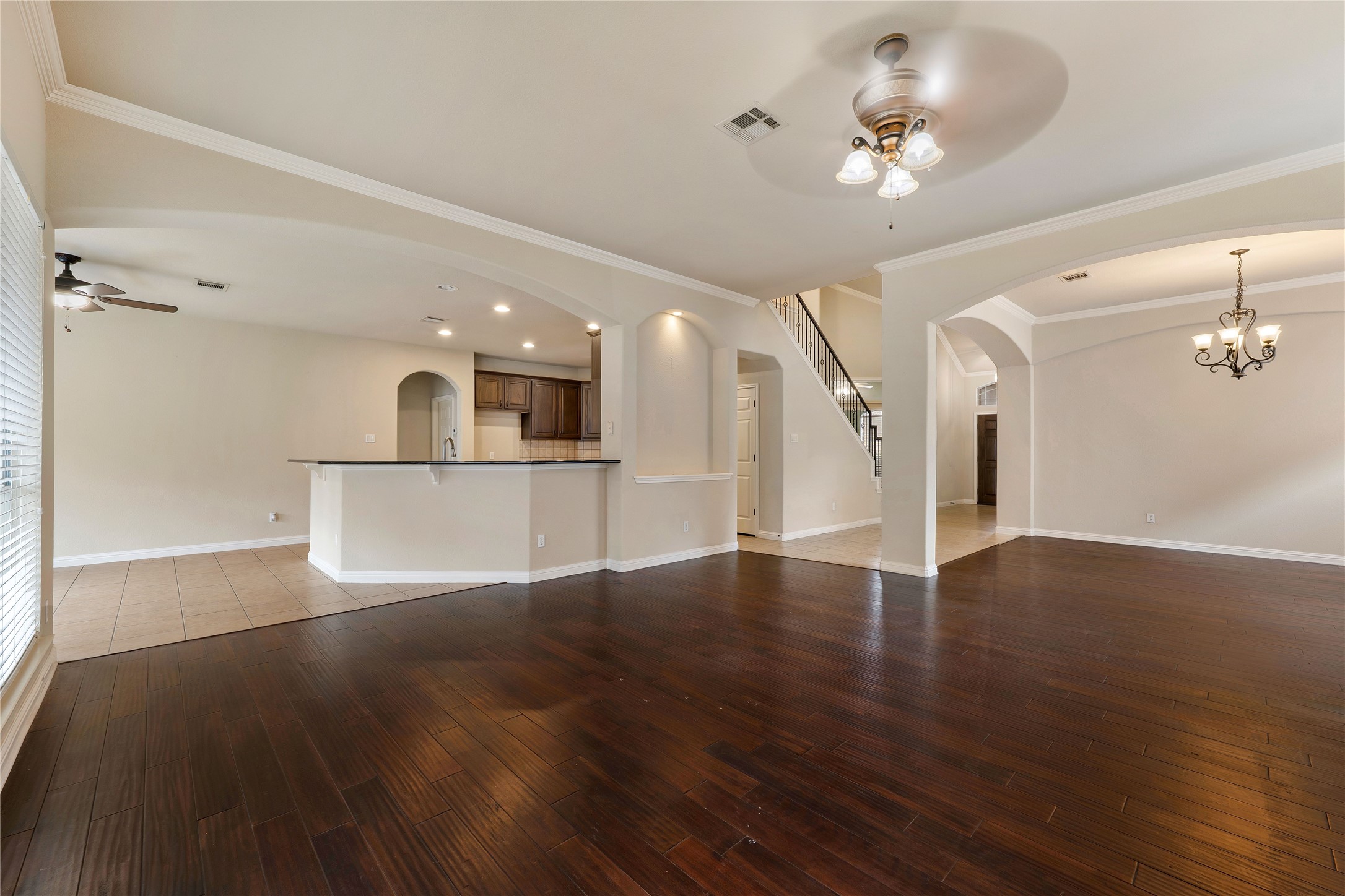1102 Canyon Maple Road Pflugerville, TX 78660 - Photo 6 of 21 a view of a room with wooden floor and a kitchen