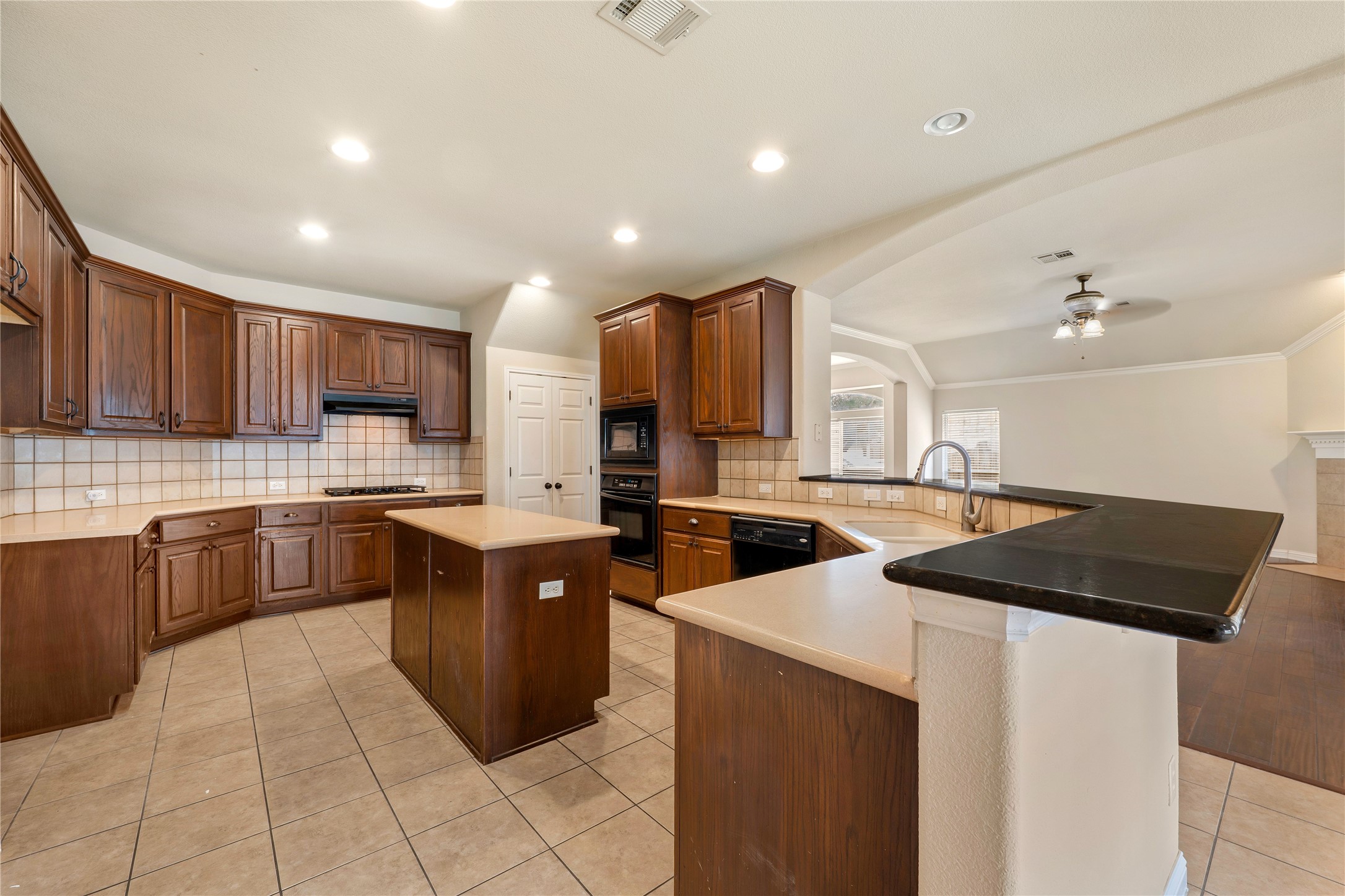 1102 Canyon Maple Road Pflugerville, TX 78660 - Photo 8 of 21 a kitchen with a cabinets and white stainless steel appliances