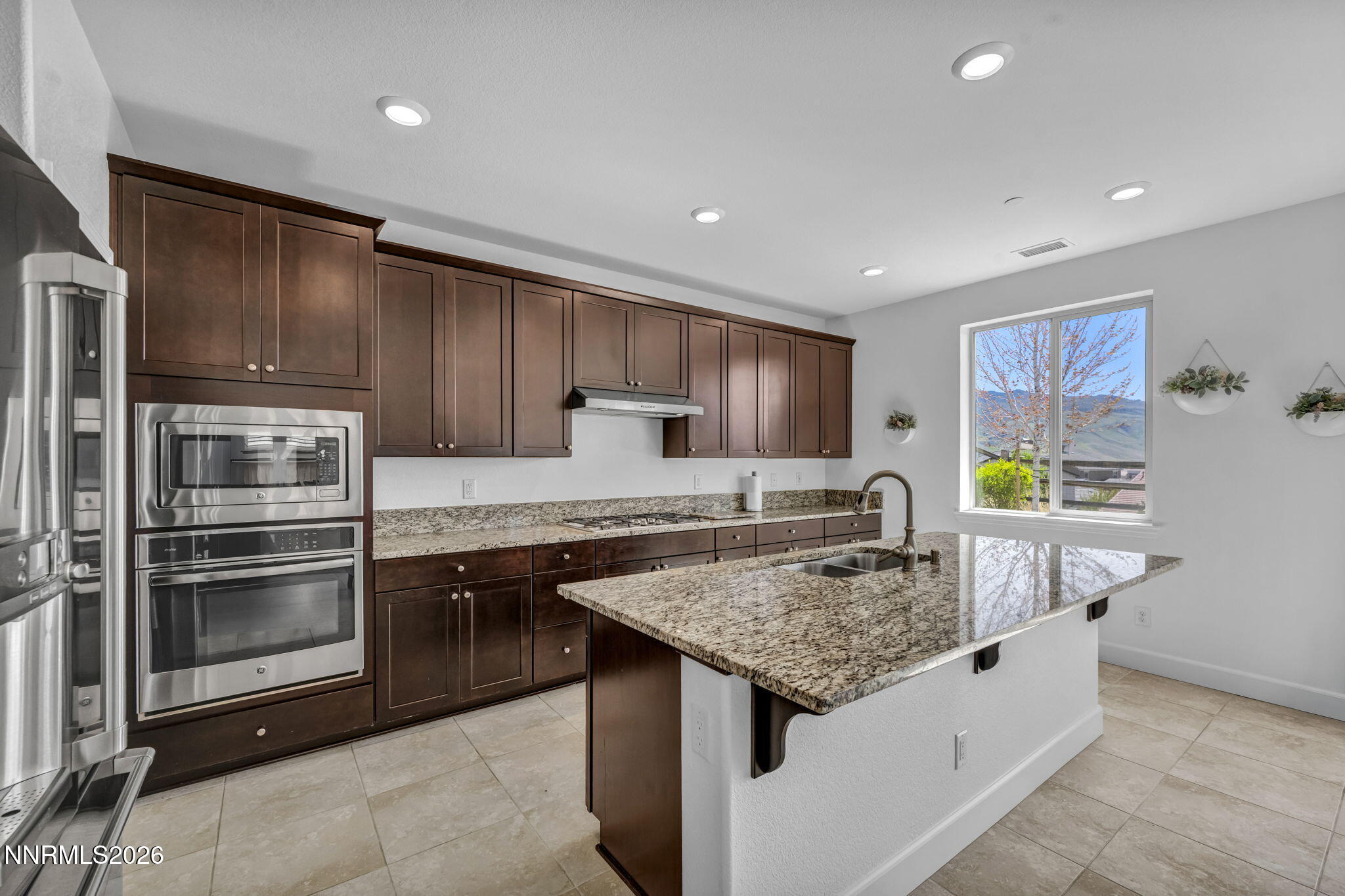 1785 Verdi Vista Court Reno, NV 89523 - Photo 13 of 35 a kitchen with stainless steel appliances granite countertop a sink and a refrigerator