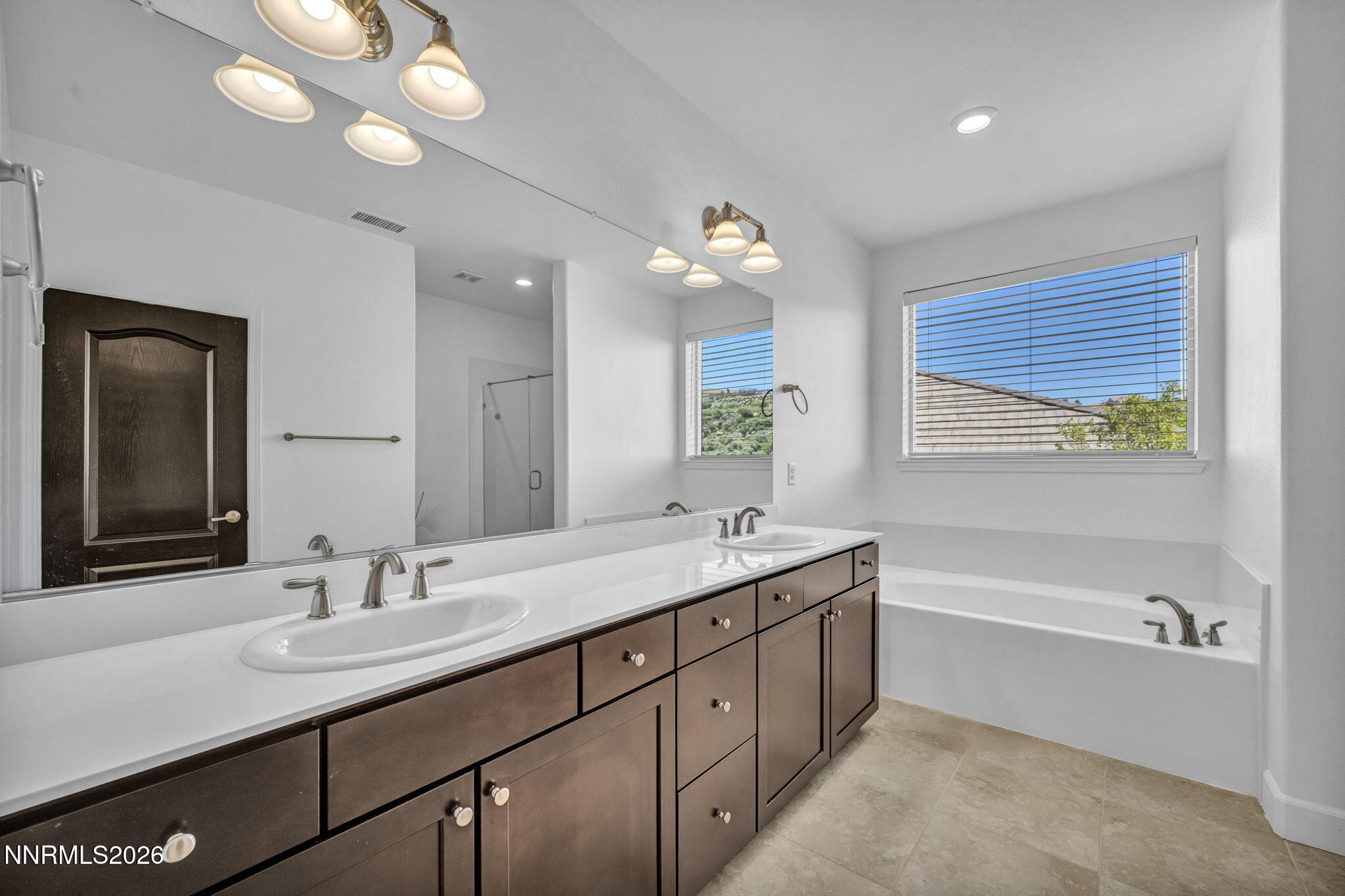 1785 Verdi Vista Court Reno, NV 89523 - Photo 19 of 35 a bathroom with a granite countertop sink a large mirror and a bathtub