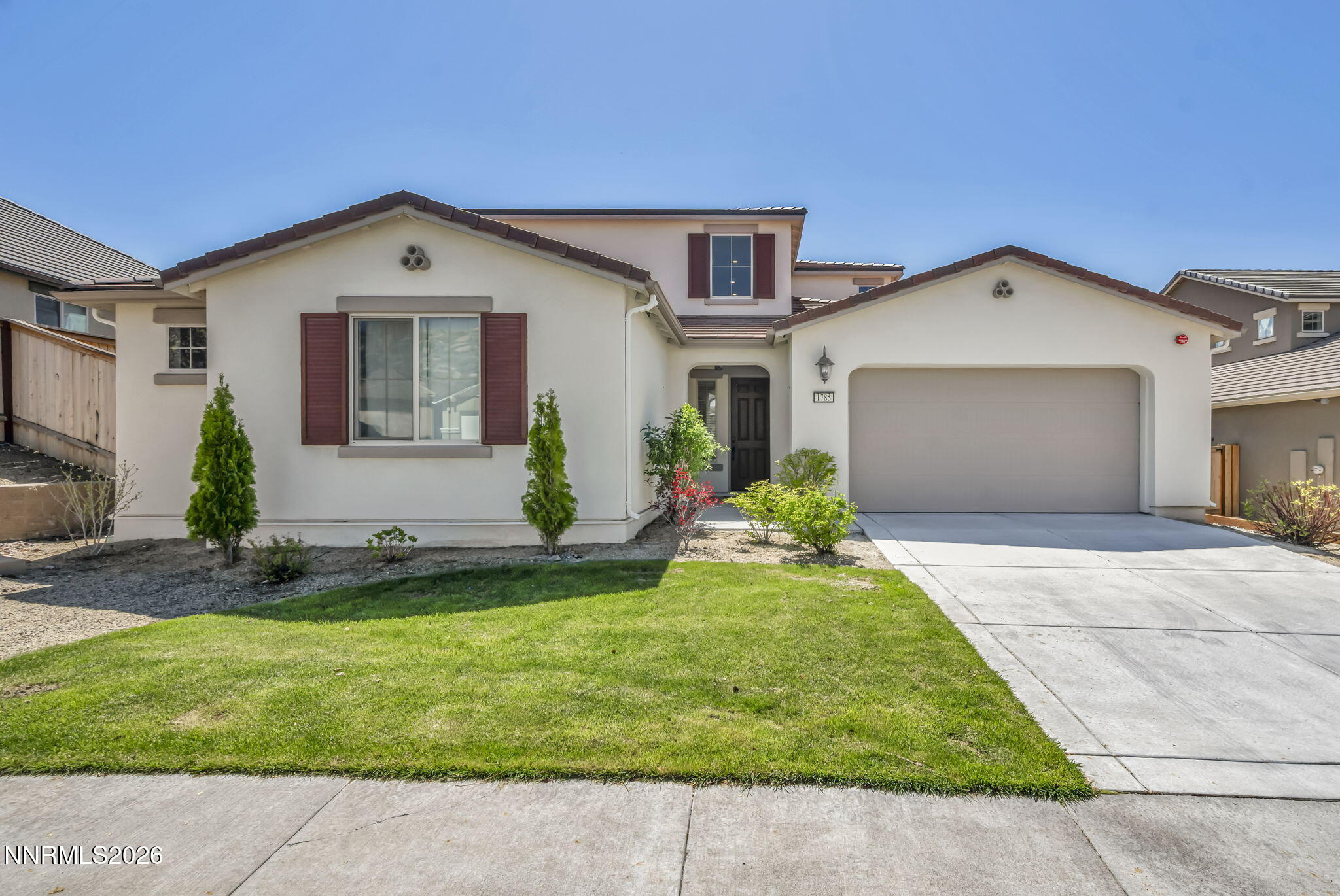 1785 Verdi Vista Court Reno, NV 89523 - Photo 2 of 35 a front view of a house with a yard and garage