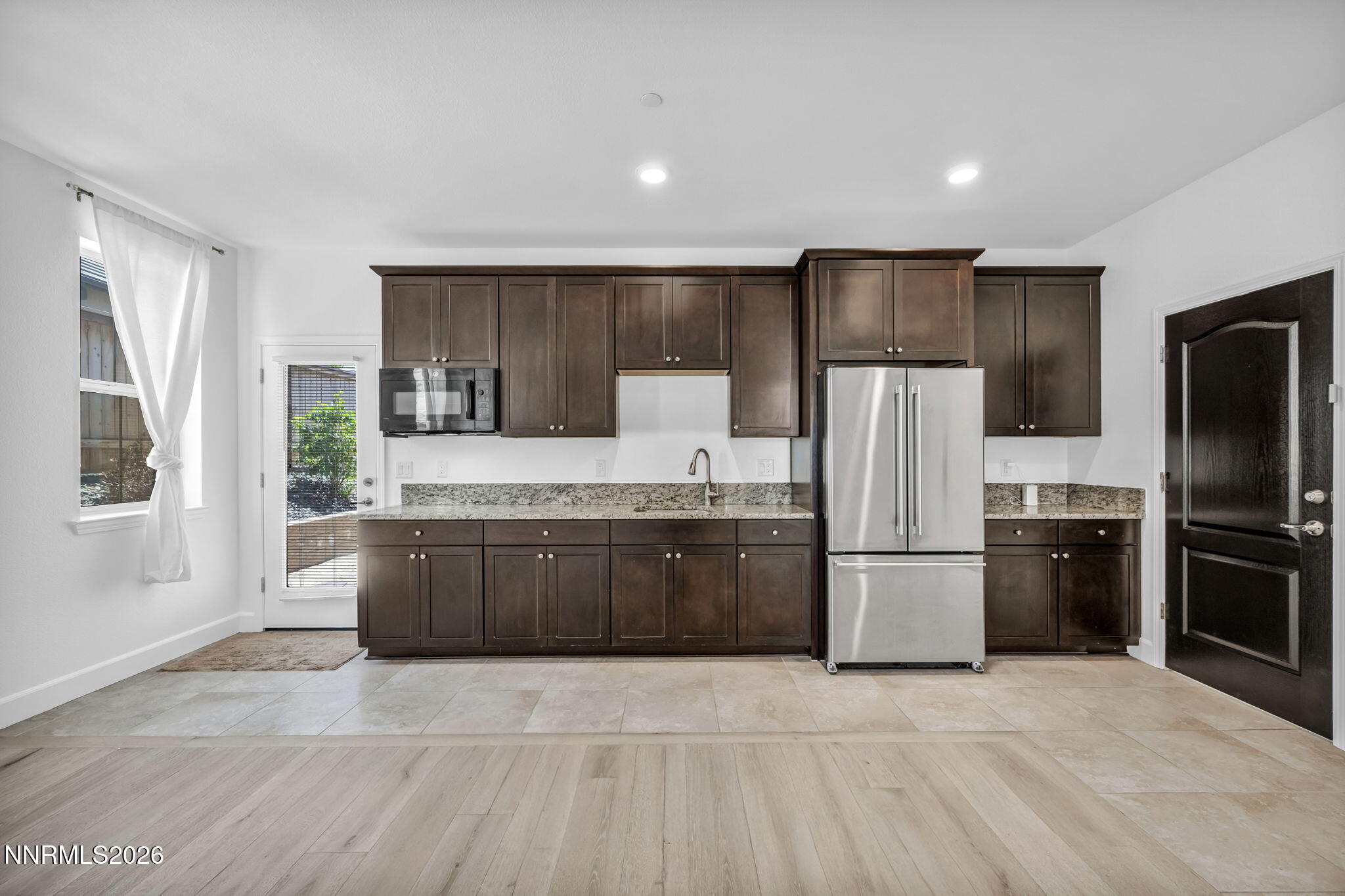 1785 Verdi Vista Court Reno, NV 89523 - Photo 22 of 35 a large kitchen with a refrigerator stove and kitchen island