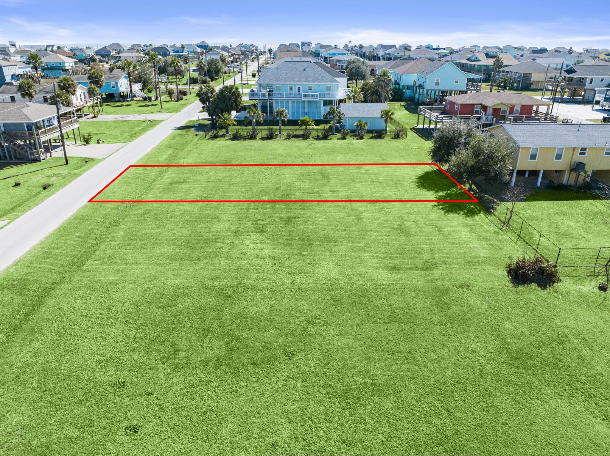 975 Wommack Crystal Beach, TX 77650 - Photo 14 of 17 a view of a big house with a big yard and large trees