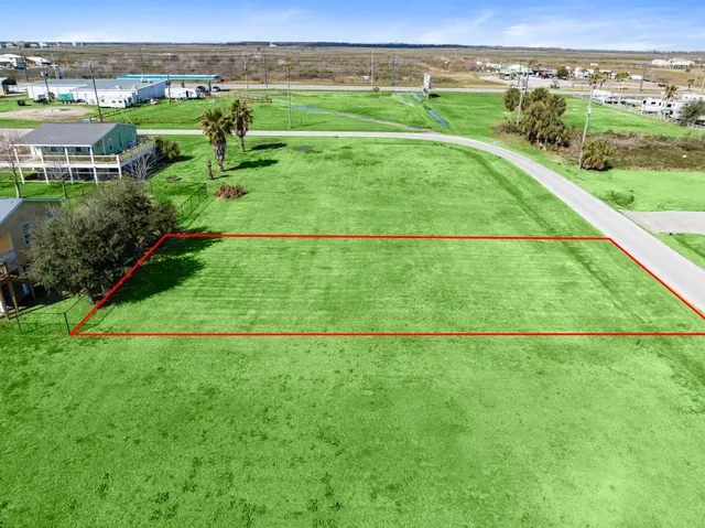 a view of a big house with a big yard and large trees