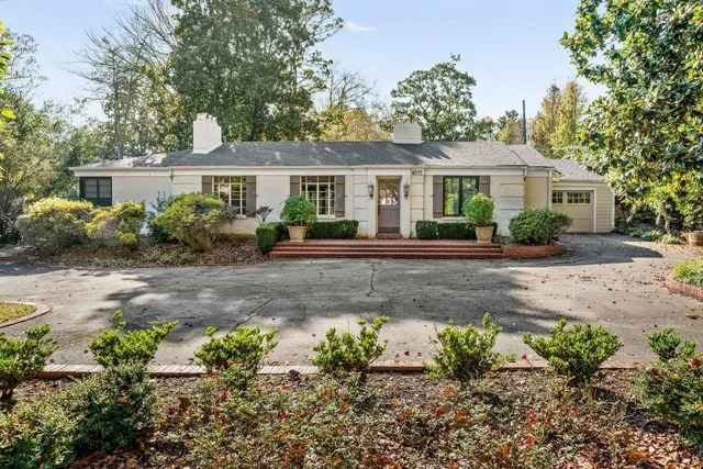 a front view of a house with a garden