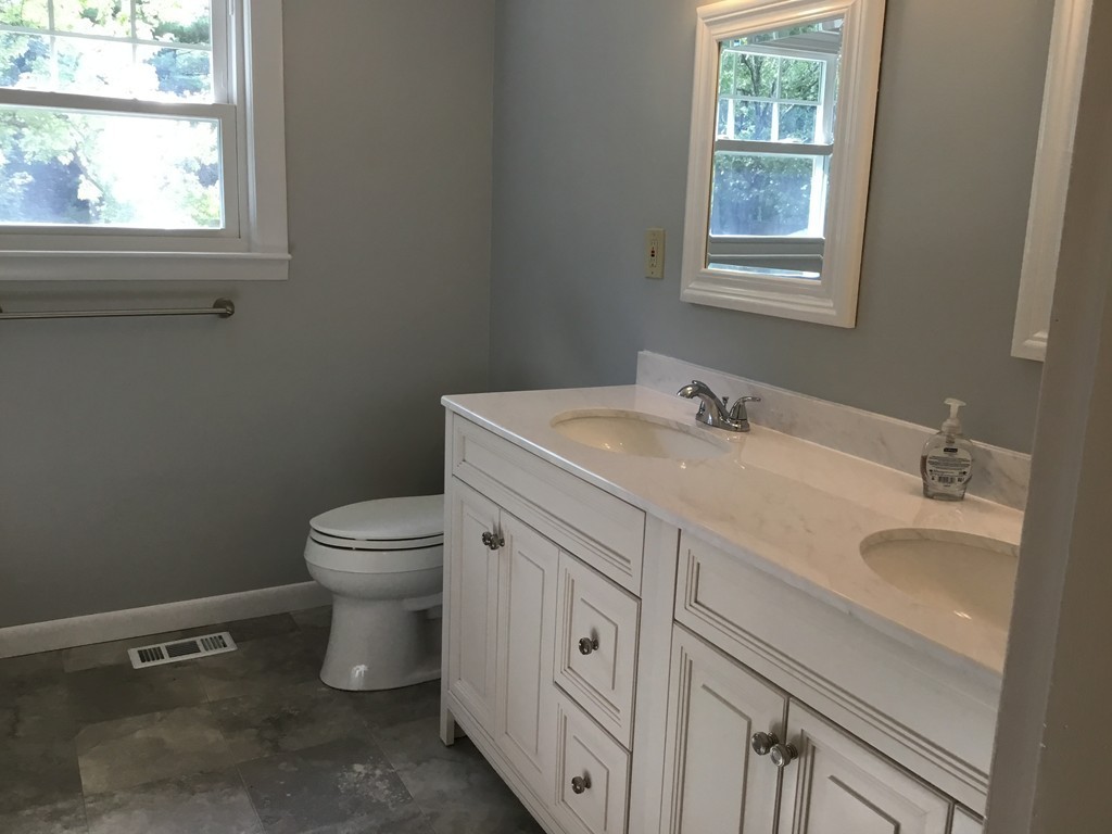29 Boston Road Sutton, MA 01590 - Photo 11 of 16 a bathroom with a granite countertop toilet sink and window