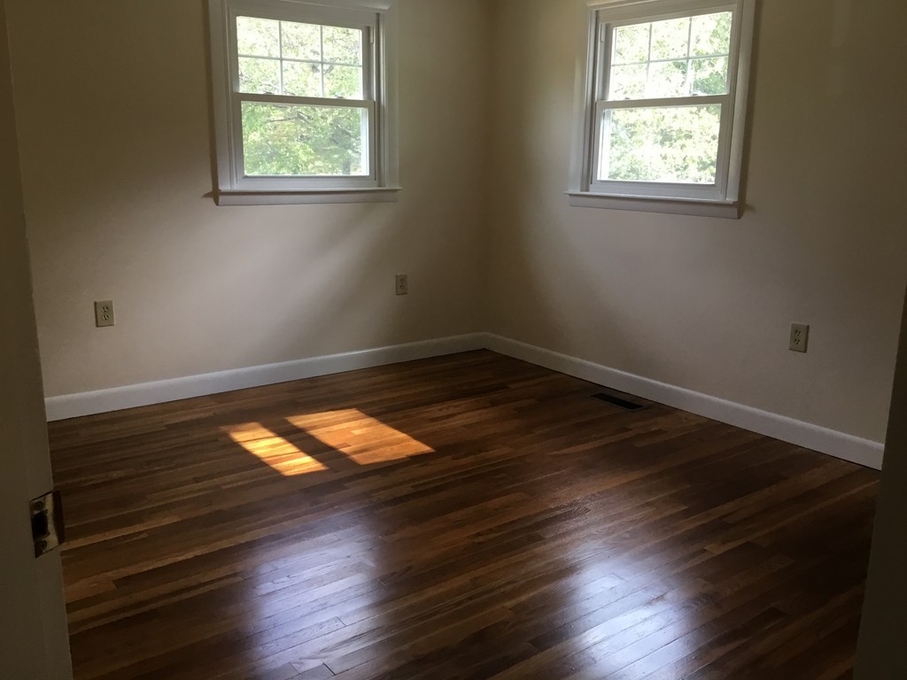 29 Boston Road Sutton, MA 01590 - Photo 12 of 16 an empty room with wooden floor and windows