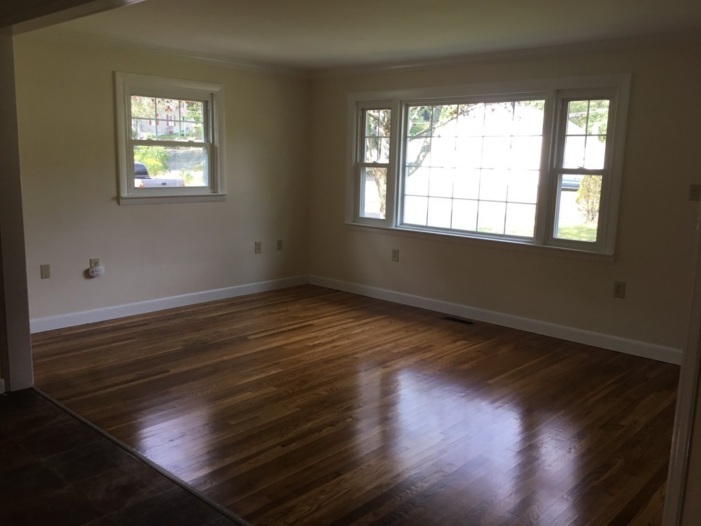 29 Boston Road Sutton, MA 01590 - Photo 6 of 16 a view of an empty room with wooden floor and a window