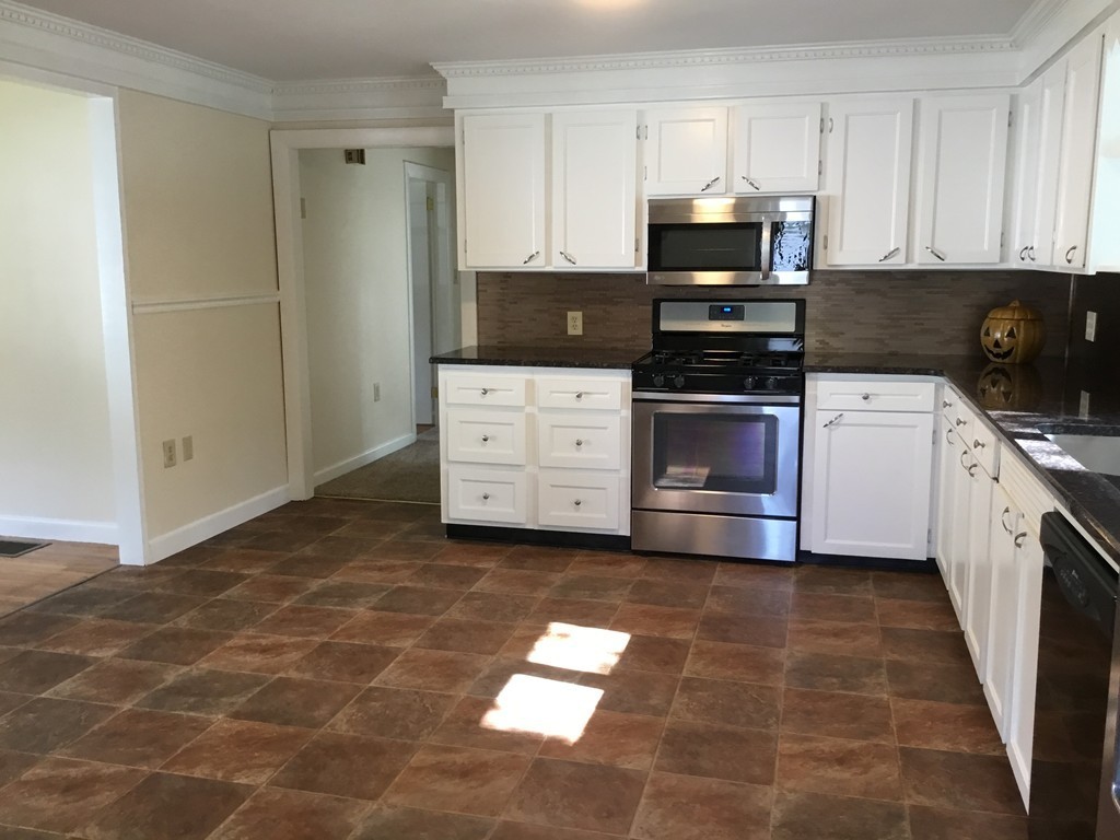29 Boston Road Sutton, MA 01590 - Photo 7 of 16 a kitchen with stainless steel appliances granite countertop a stove a sink and a microwave