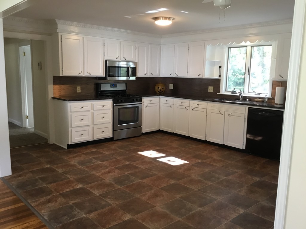 29 Boston Road Sutton, MA 01590 - Photo 8 of 16 a kitchen with stainless steel appliances granite countertop a stove a sink and a granite counter tops