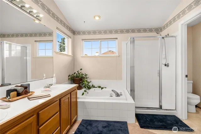 a bathroom with a tub sink and mirror