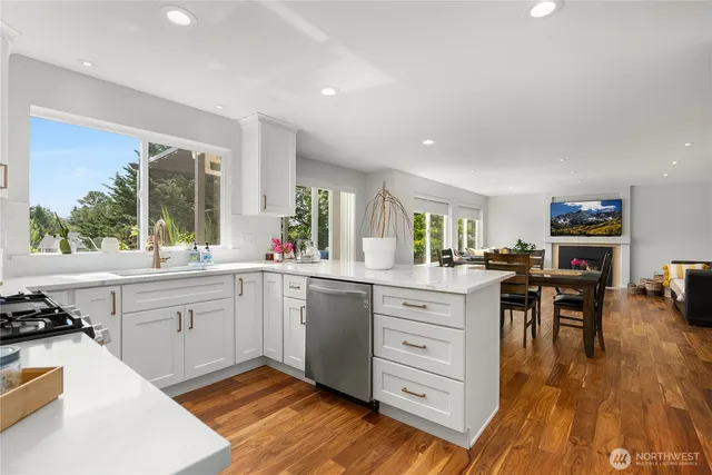 a kitchen with white cabinets and sink