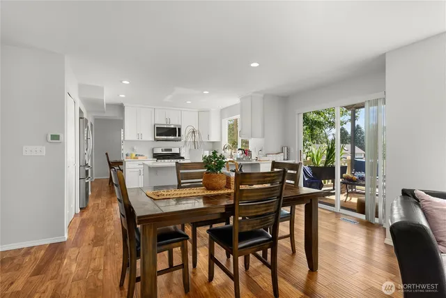 a view of a dining room with furniture and wooden floor