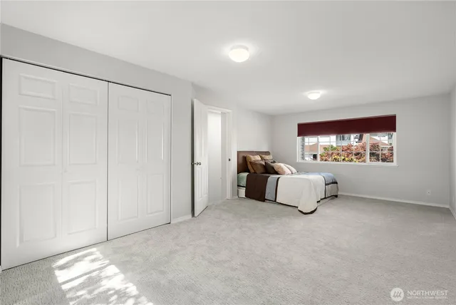 a living room with furniture and a wall painting