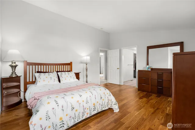 a bedroom with a bed and wooden floor