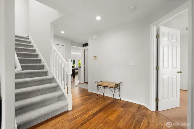 a view of entryway and hall with wooden floor