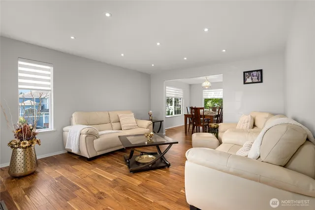 a living room with furniture and a wooden floor