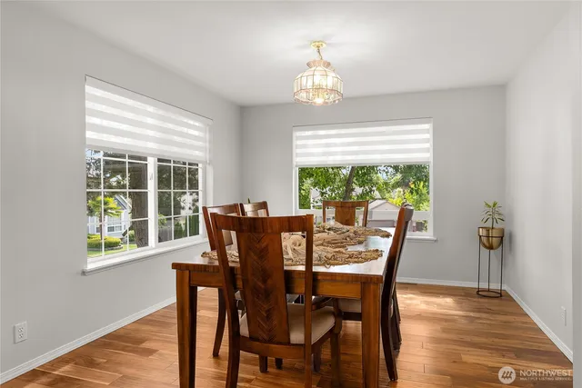 a view of a dining room with furniture window and wooden floor
