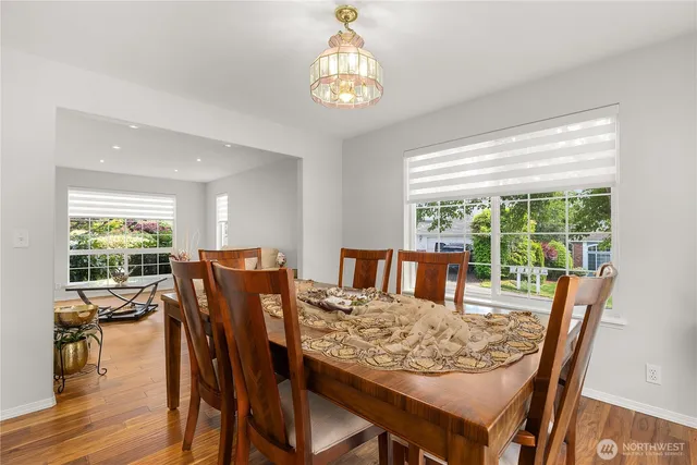 a view of a dining room with furniture window and wooden floor