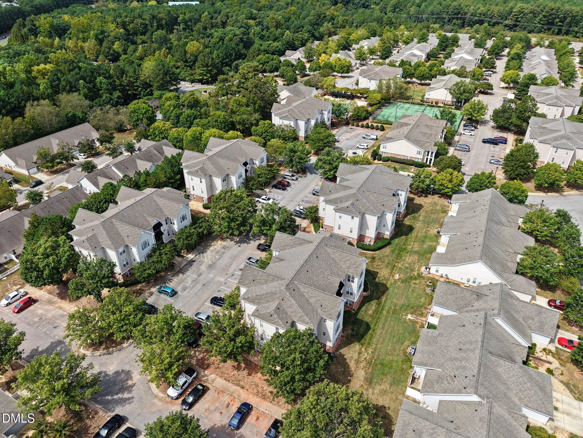 2521 Friedland Place Raleigh, NC 27617 - Photo 19 of 21 Aerial perspective highlighting tree-lined internal streets, lush open lawns, and buffered greenways ideal for morning walks or pet exercise.