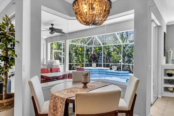 a dining room with furniture a chandelier and wooden floor