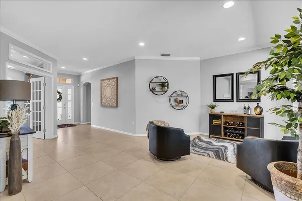 a living room with furniture a fireplace and a potted plant