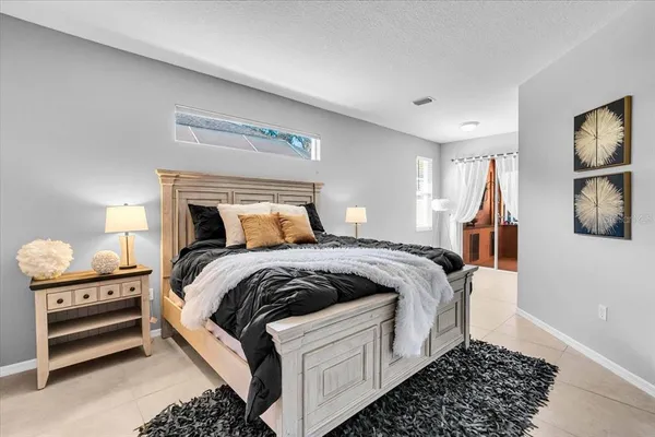 a bedroom with a bed and a window
