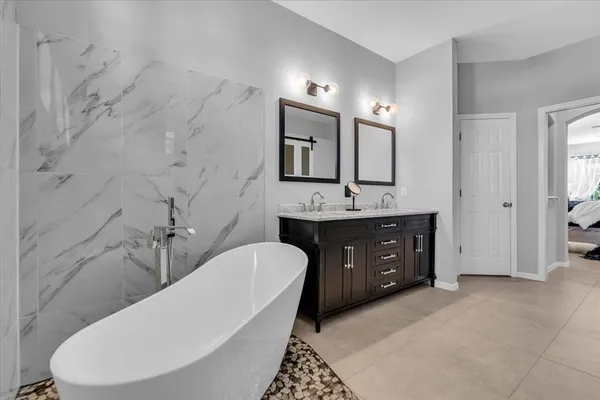 a bathroom with a double vanity sink mirror and toilet