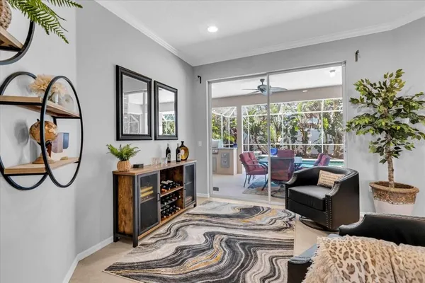 a living room with furniture a window and a chandelier