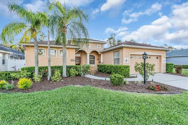 a view of a front of house with a yard and potted plants