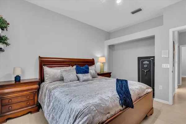 a bedroom with a large bed and a lamp on table