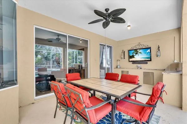 a outdoor dining space with a table and chairs