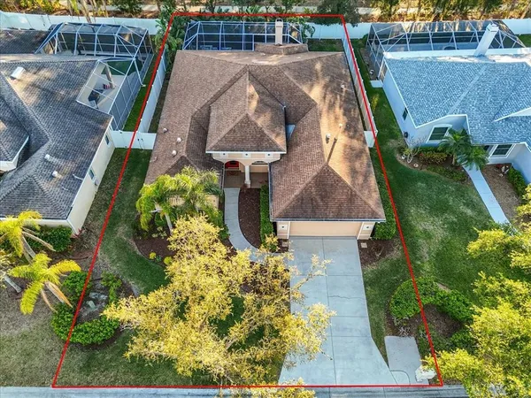 an aerial view of a house with a yard basket ball court and outdoor seating
