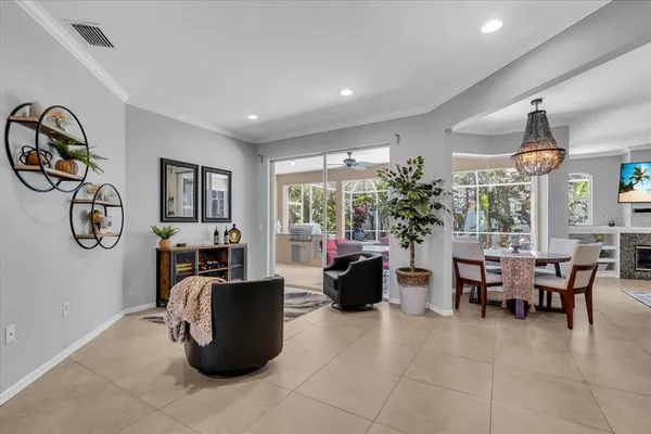 a living room with furniture a window and a potted plant